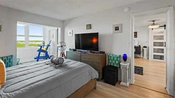 a bedroom with a bed and a flat screen tv