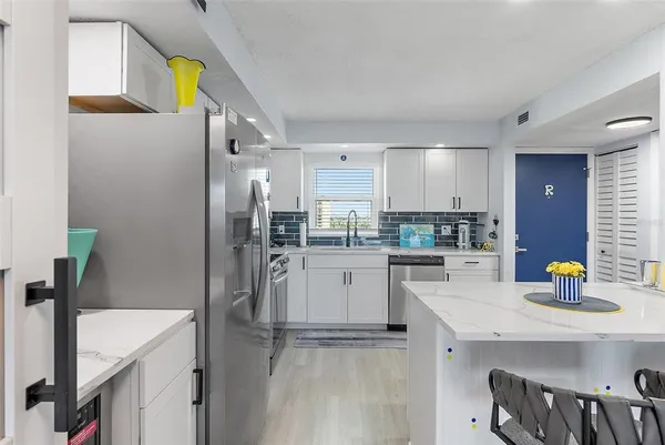 a kitchen with a sink stainless steel appliances and cabinets
