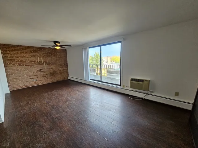 a view of an empty room and wooden floor