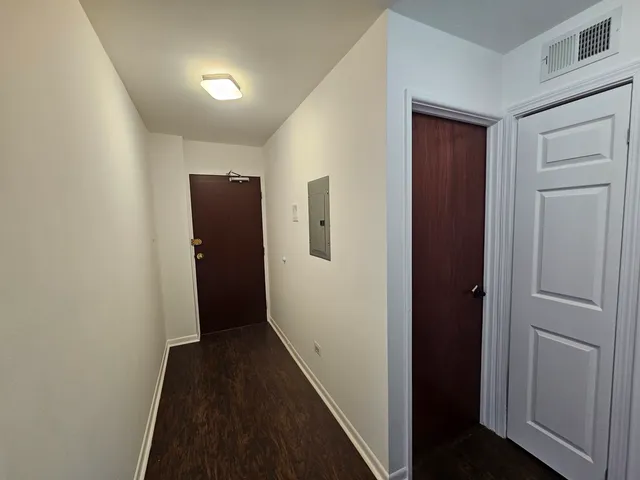 a view of hallway with wooden floor