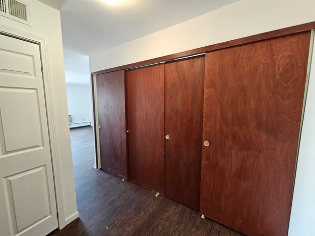 a view of a hallway with wooden floor