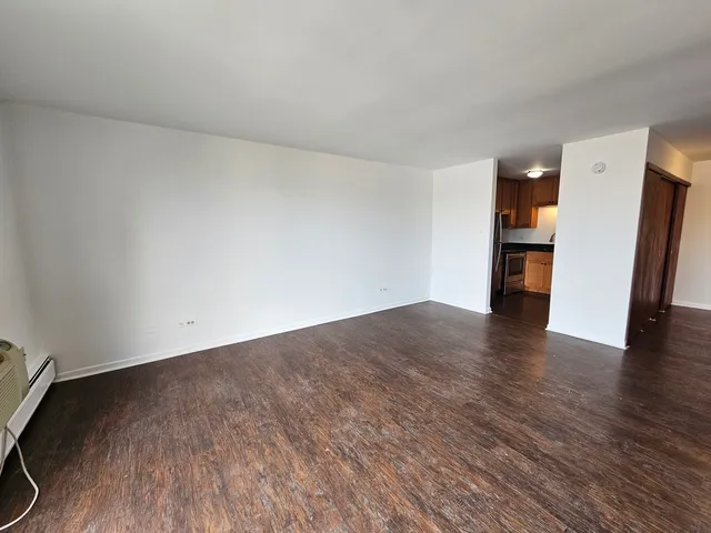 a kitchen with granite countertop stainless steel appliances a refrigerator a sink and cabinets