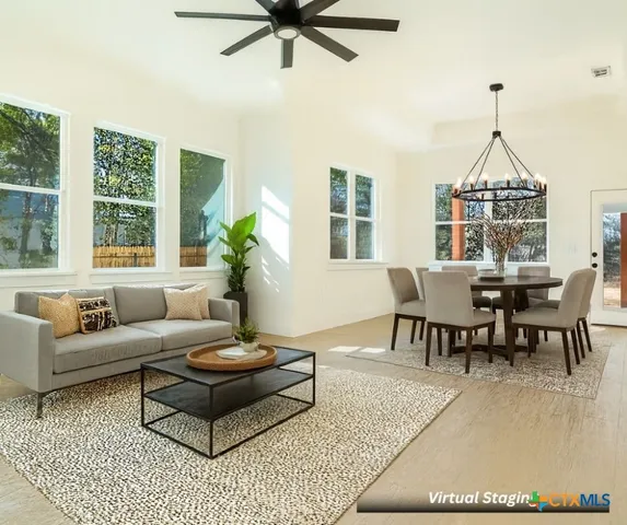 a living room with furniture a chandelier and a window