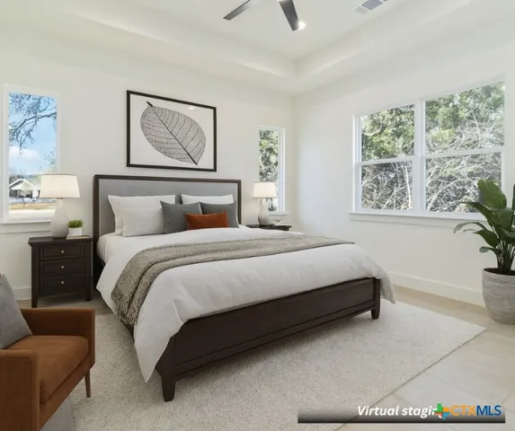 a spacious bedroom with a bed a couch and a window