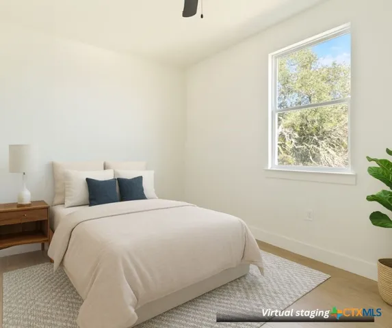 a bedroom with a bed and a window