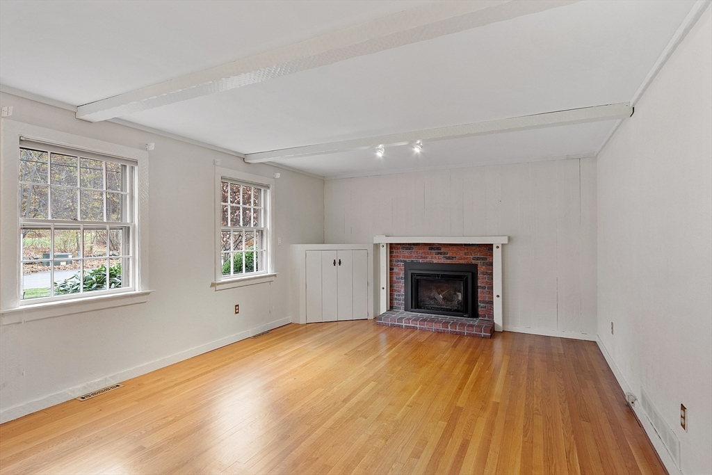 14 Ocean Street Manchester, MA 01944 - Photo 11 of 25 wooden floor fireplace and windows in an empty room