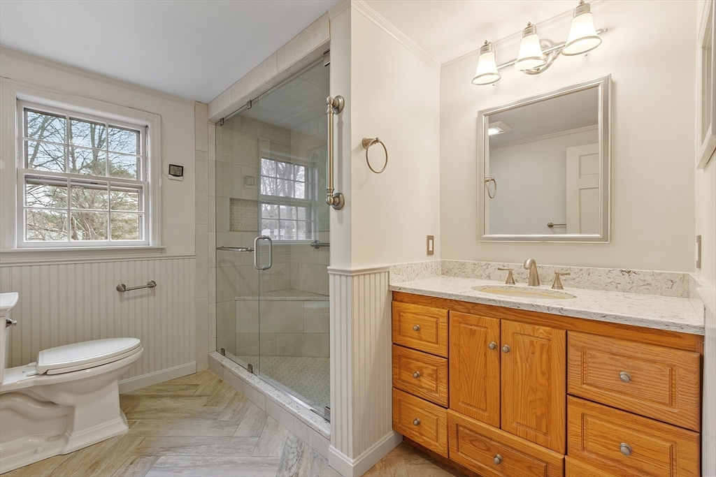 14 Ocean Street Manchester, MA 01944 - Photo 19 of 25 a bathroom with a granite countertop sink a toilet and a mirror