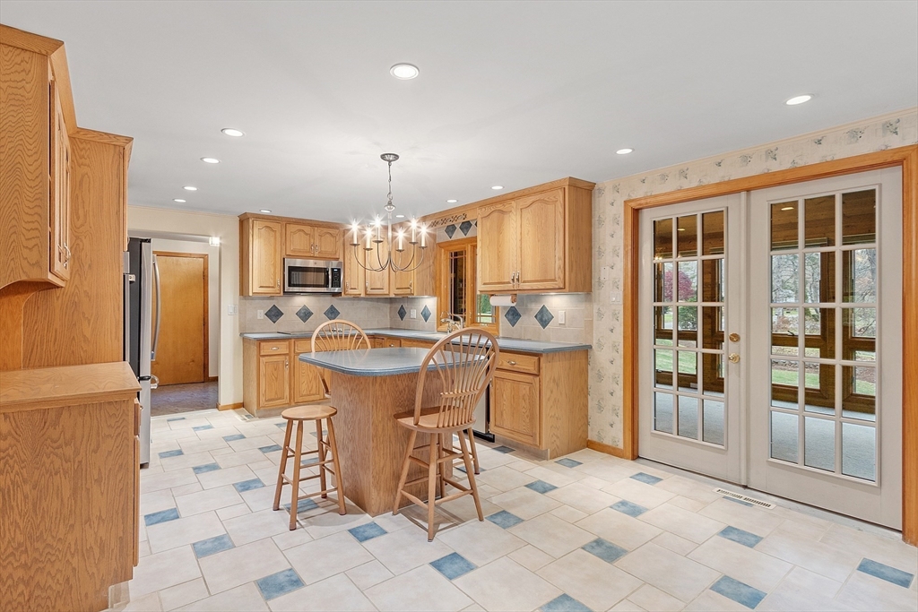 14 Ocean Street Manchester, MA 01944 - Photo 4 of 25 a kitchen with stainless steel appliances kitchen island granite countertop a refrigerator and a sink