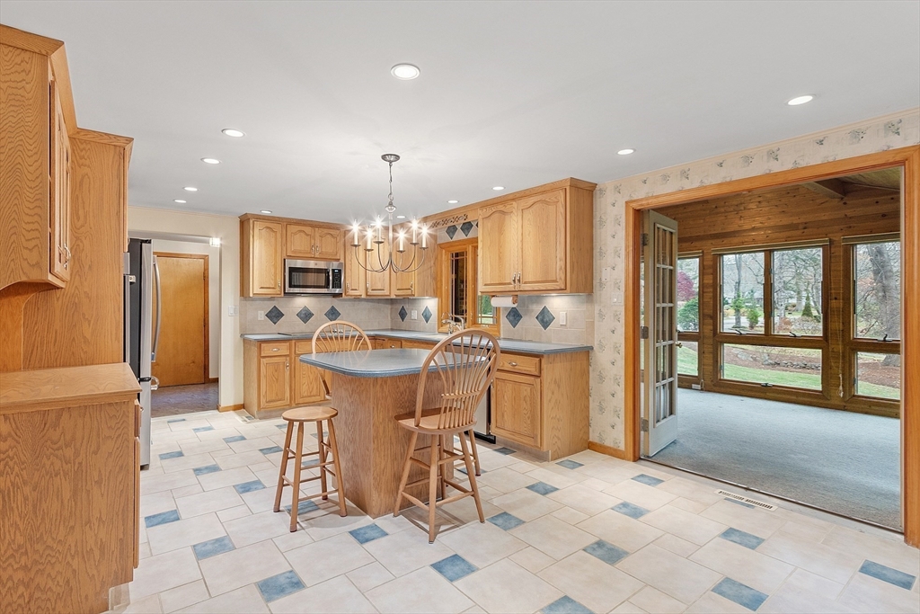14 Ocean Street Manchester, MA 01944 - Photo 5 of 25 a kitchen with stainless steel appliances kitchen island granite countertop a refrigerator and a sink