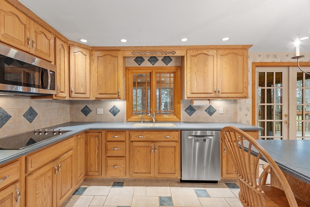 14 Ocean Street Manchester, MA 01944 - Photo 6 of 25 a kitchen with stainless steel appliances granite countertop a stove and a sink