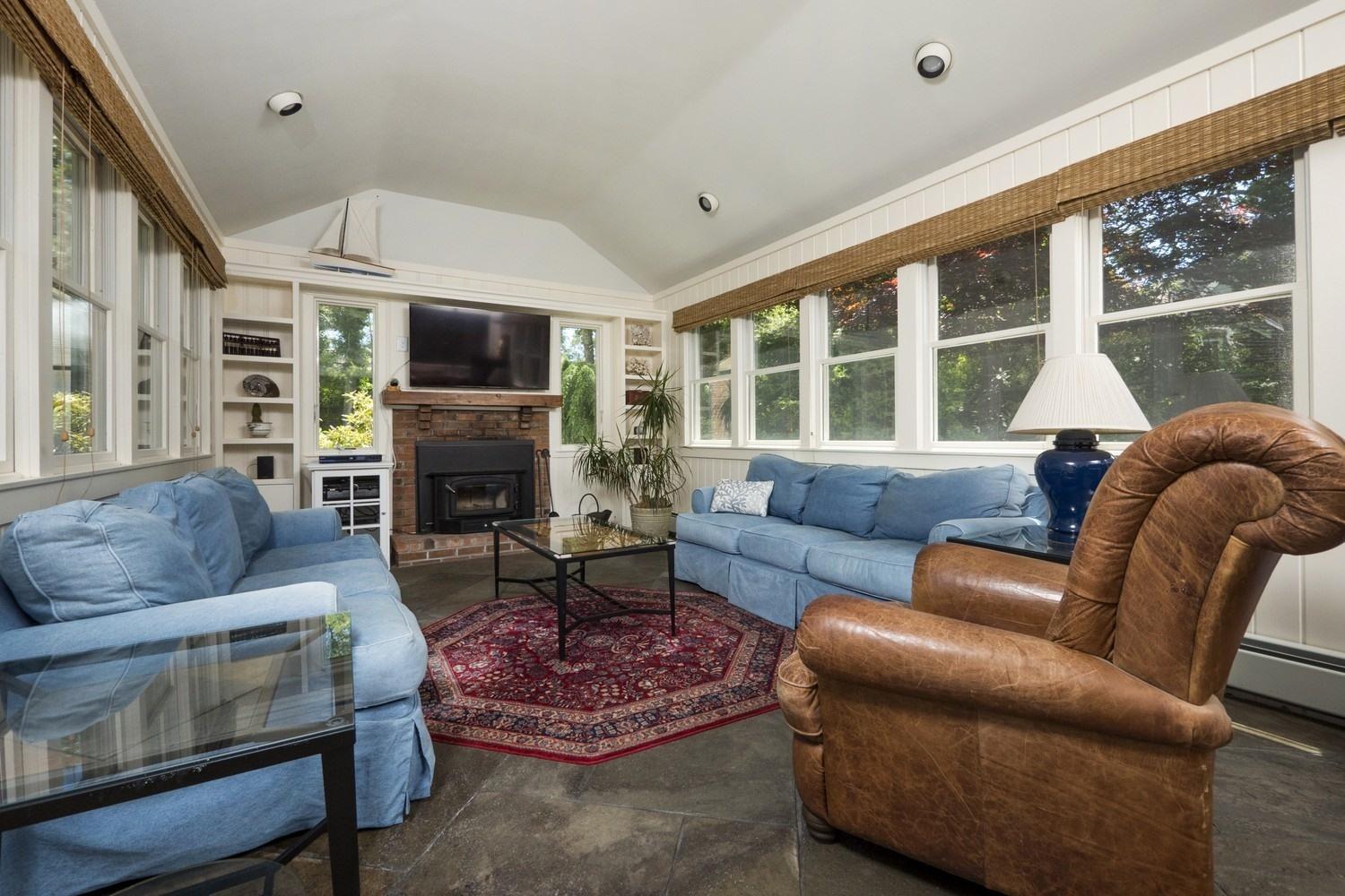 45 Gibson Road Orleans, MA 02653 - Photo 12 of 28 a living room with furniture fireplace and a large window