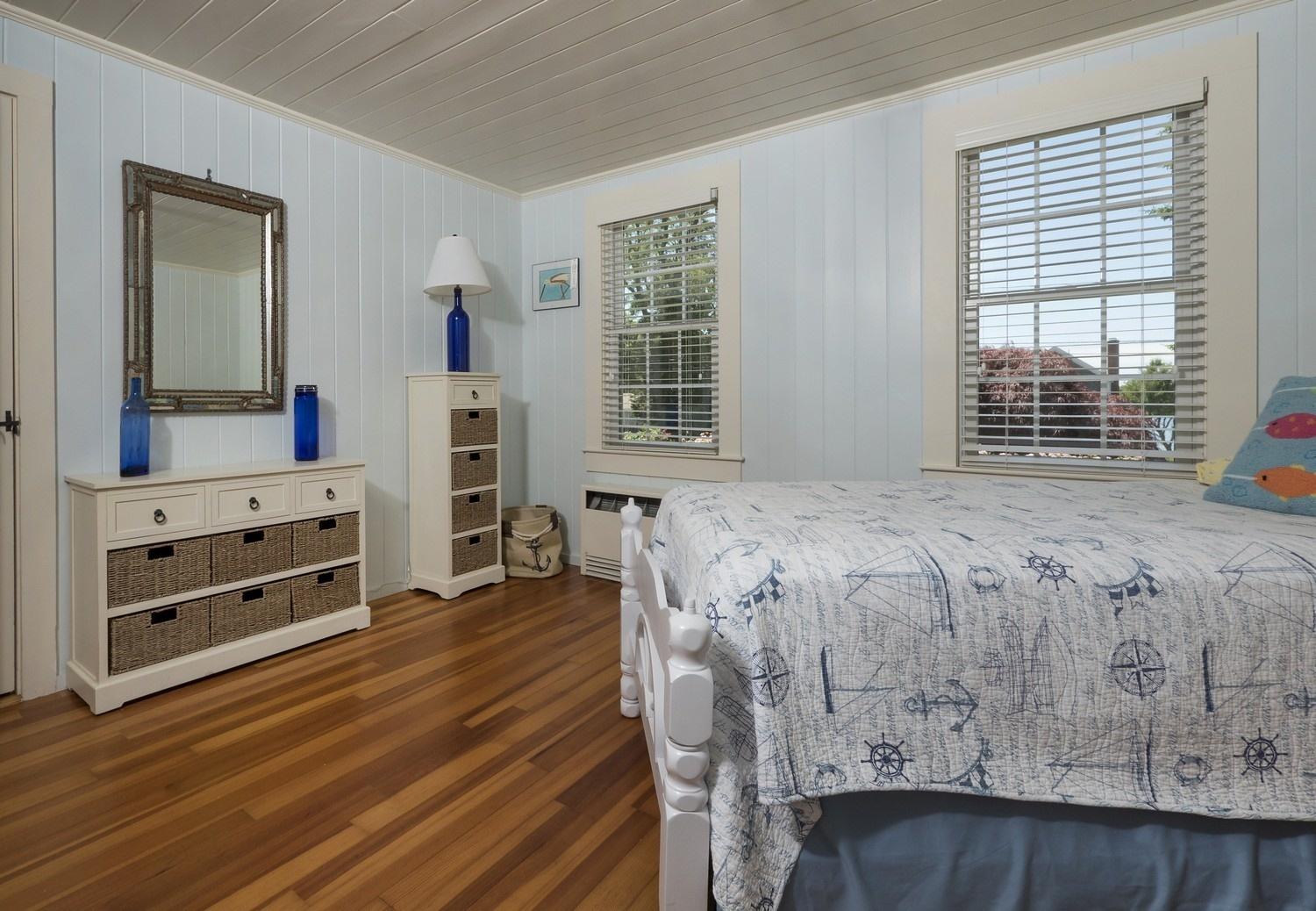 45 Gibson Road Orleans, MA 02653 - Photo 14 of 28 a bedroom with a bed and a flat tv screen on dresser