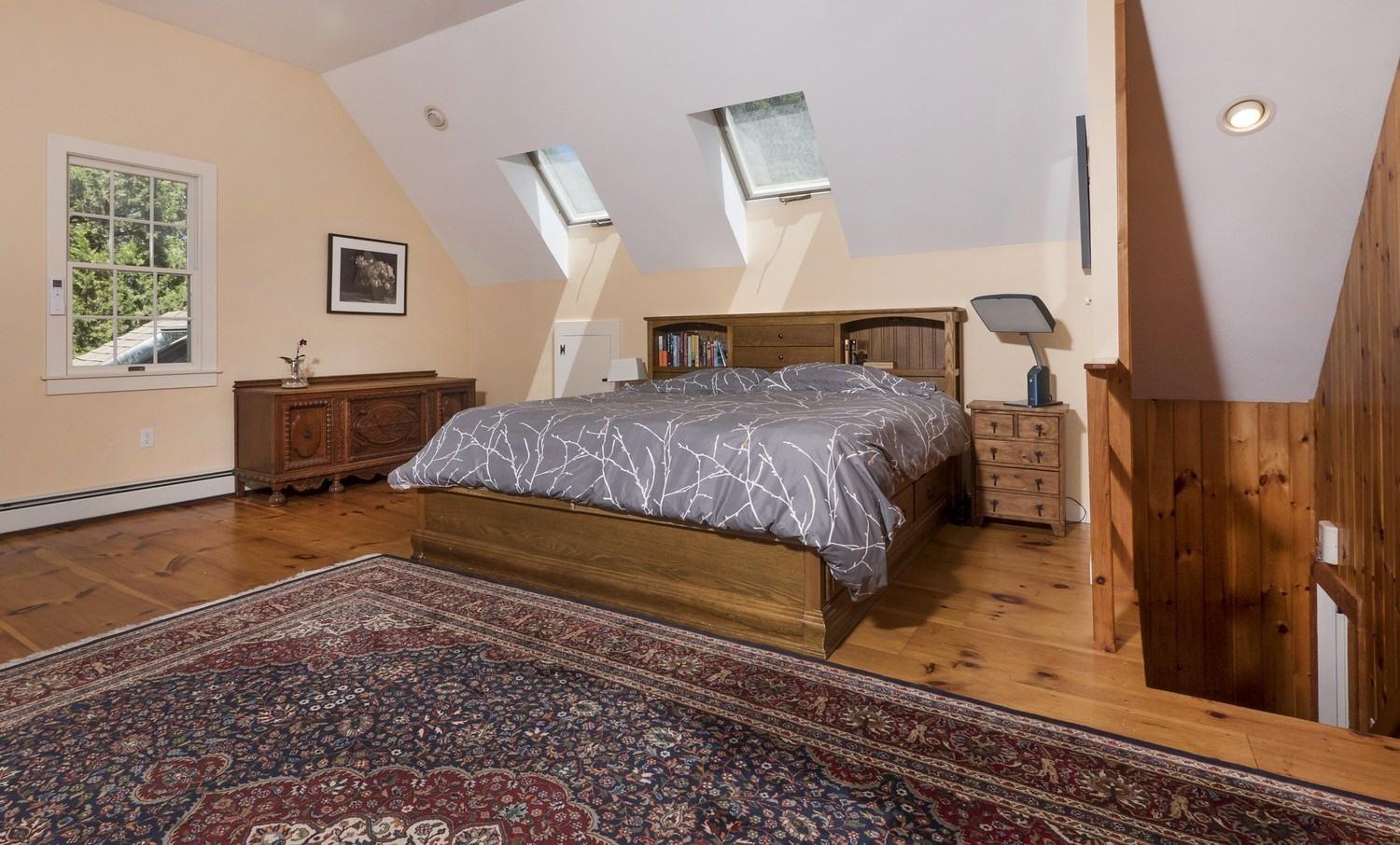 45 Gibson Road Orleans, MA 02653 - Photo 19 of 28 a bedroom with a bed and wooden floor