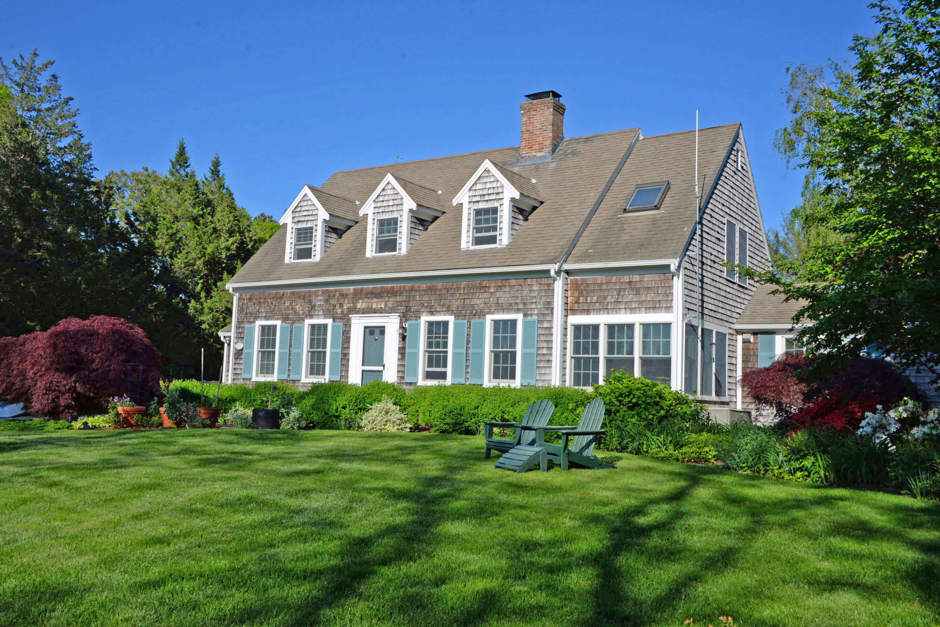 45 Gibson Road Orleans, MA 02653 - Photo 3 of 28 a front view of a house with a garden