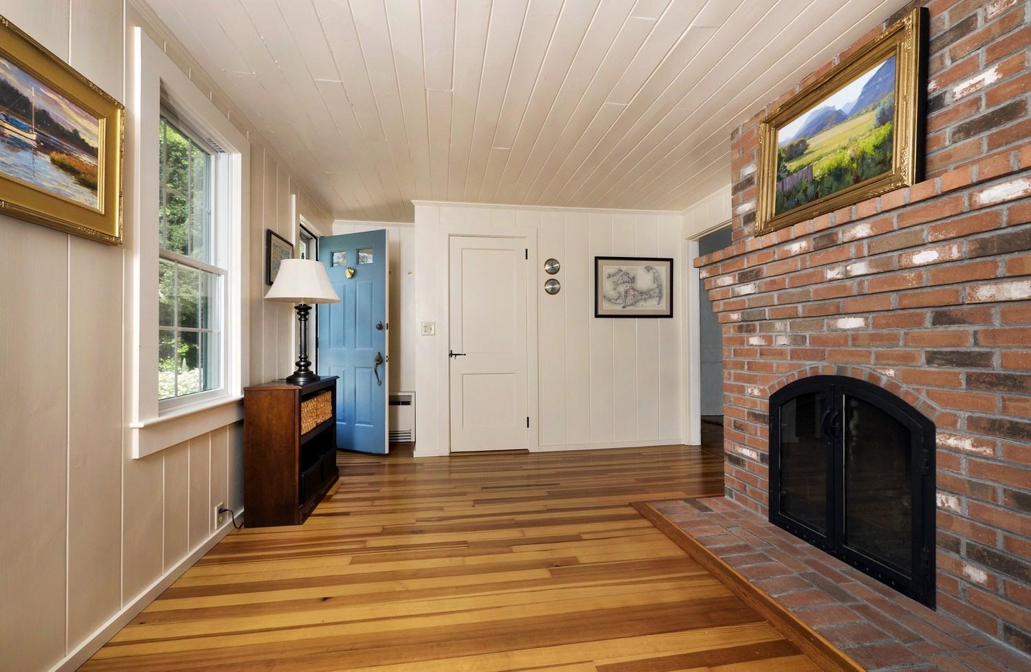 45 Gibson Road Orleans, MA 02653 - Photo 4 of 28 a living room with furniture and a fireplace