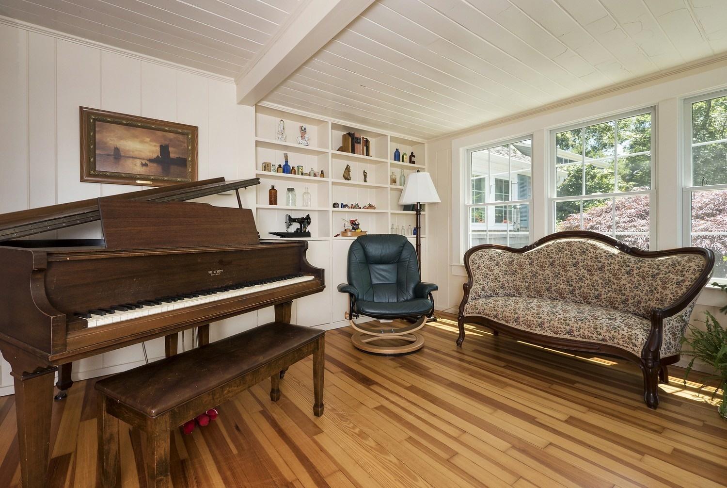 45 Gibson Road Orleans, MA 02653 - Photo 5 of 28 a living room with furniture a rug potted plant and a large window