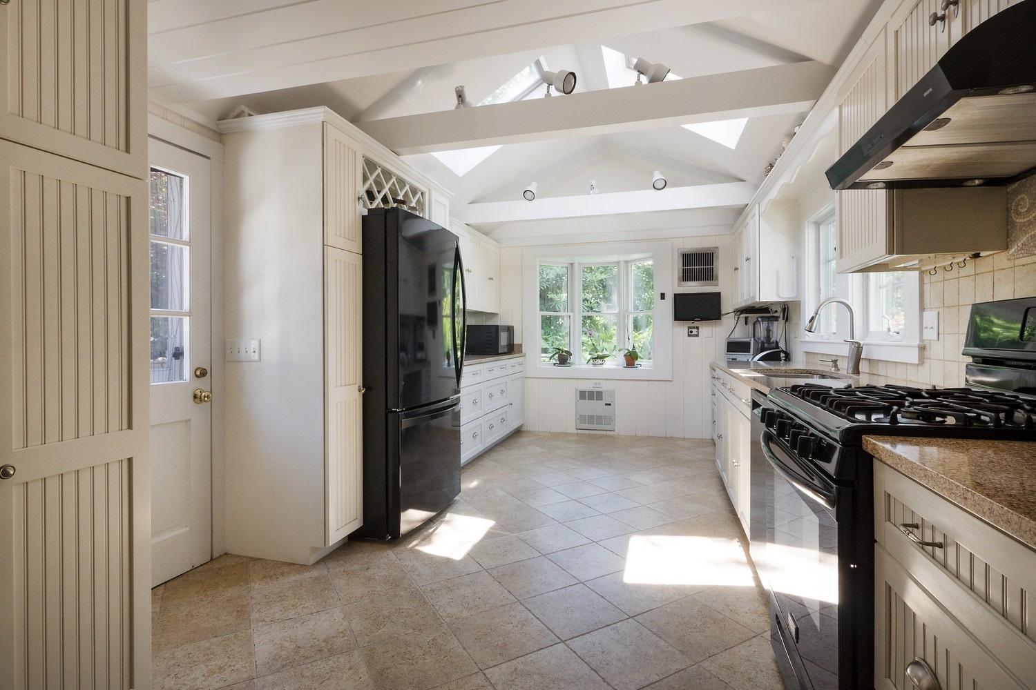 45 Gibson Road Orleans, MA 02653 - Photo 7 of 28 a kitchen with stainless steel appliances granite countertop a stove a refrigerator and a sink