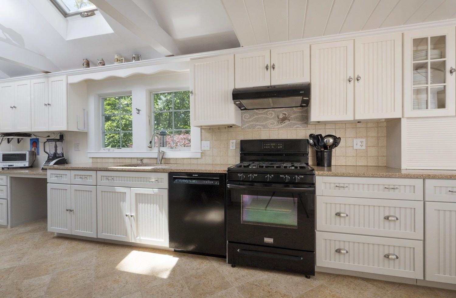 45 Gibson Road Orleans, MA 02653 - Photo 8 of 28 a kitchen with cabinets appliances and a window