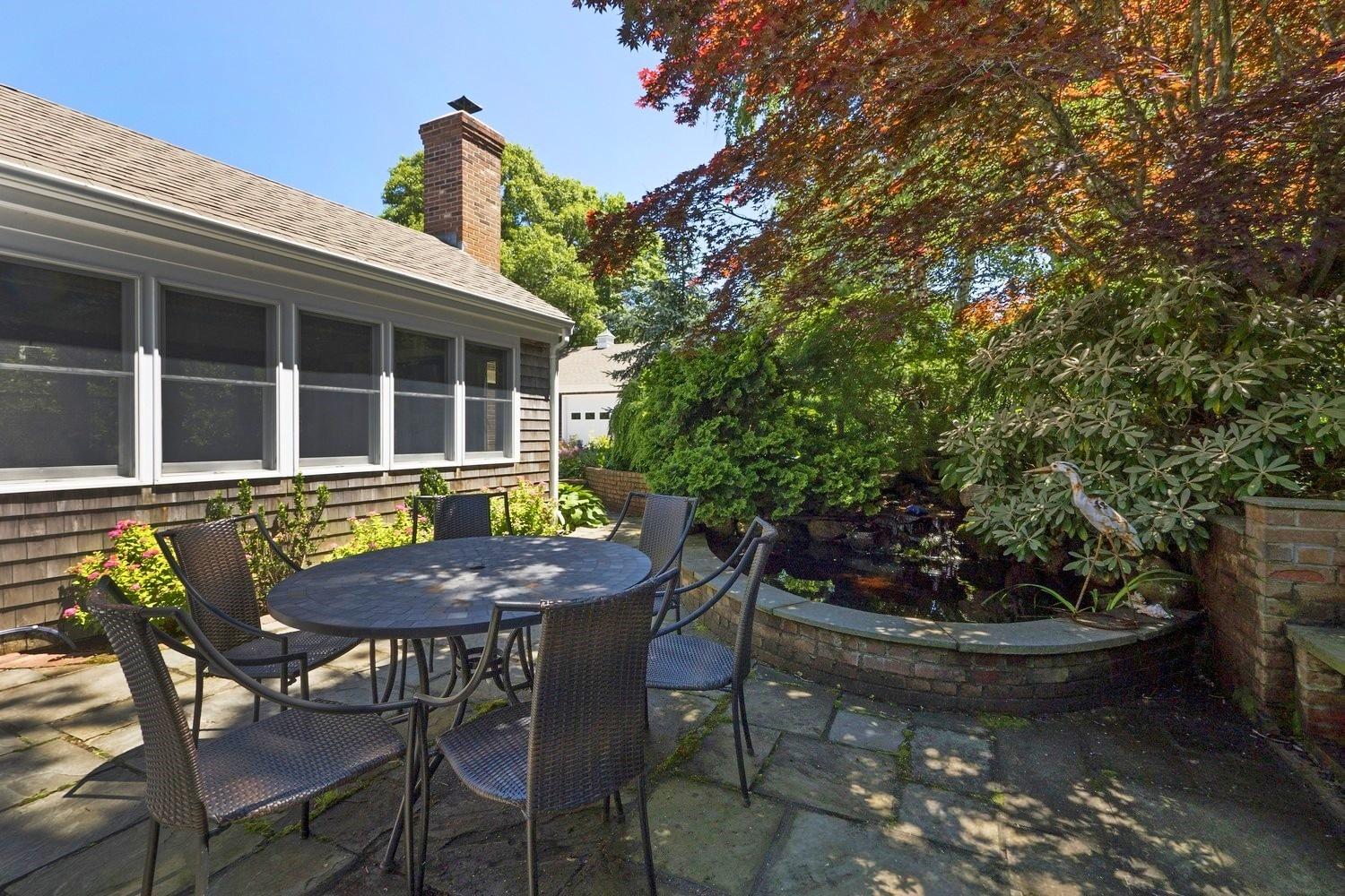 45 Gibson Road Orleans, MA 02653 - Photo 9 of 28 a view of a table and chairs in patio of the house