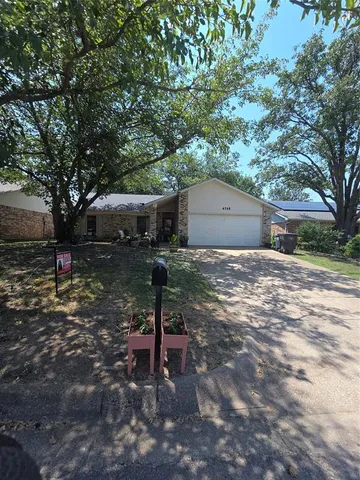 a backyard of a house with barbeque oven table and chairs