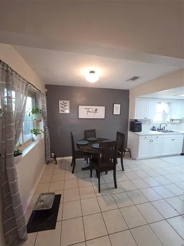 a view of a dining room with furniture and chandelier