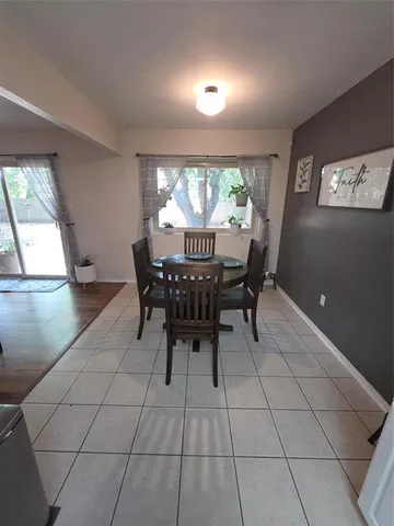 a view of a dining room with furniture and a large window