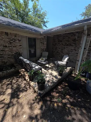 a backyard of a house with table and chairs