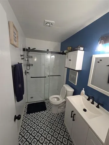 a bathroom with a sink toilet and shower