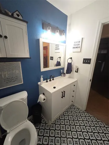 a bathroom with a sink toilet and mirror