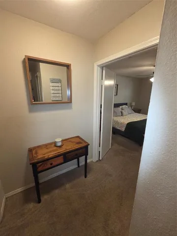 a bedroom with a bed and a lamp on table