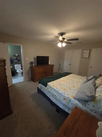 a bedroom with a bed and a flat screen television