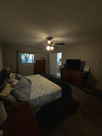 a bed sitting in a room next to a window