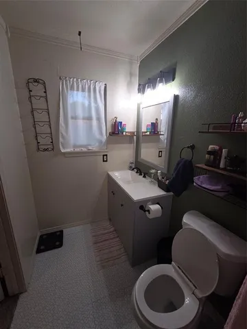 a bathroom with a toilet sink and mirror