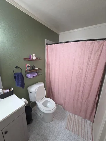 a white toilet sitting next to a small sink