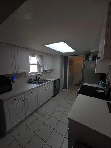 a kitchen with a sink and cabinets