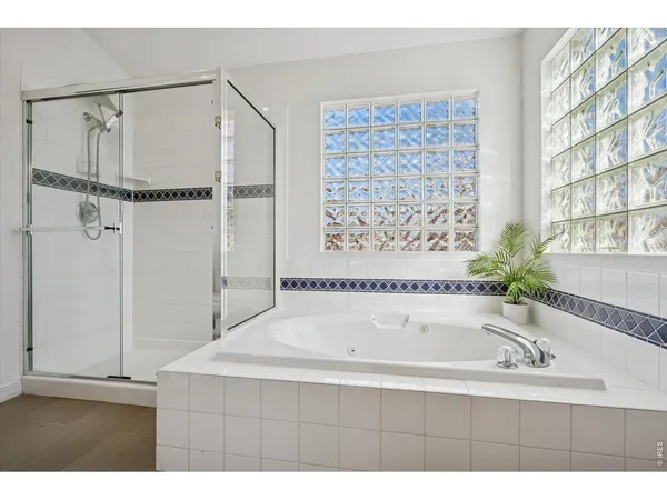 a bathroom with a granite countertop sink toilet a mirror and shower