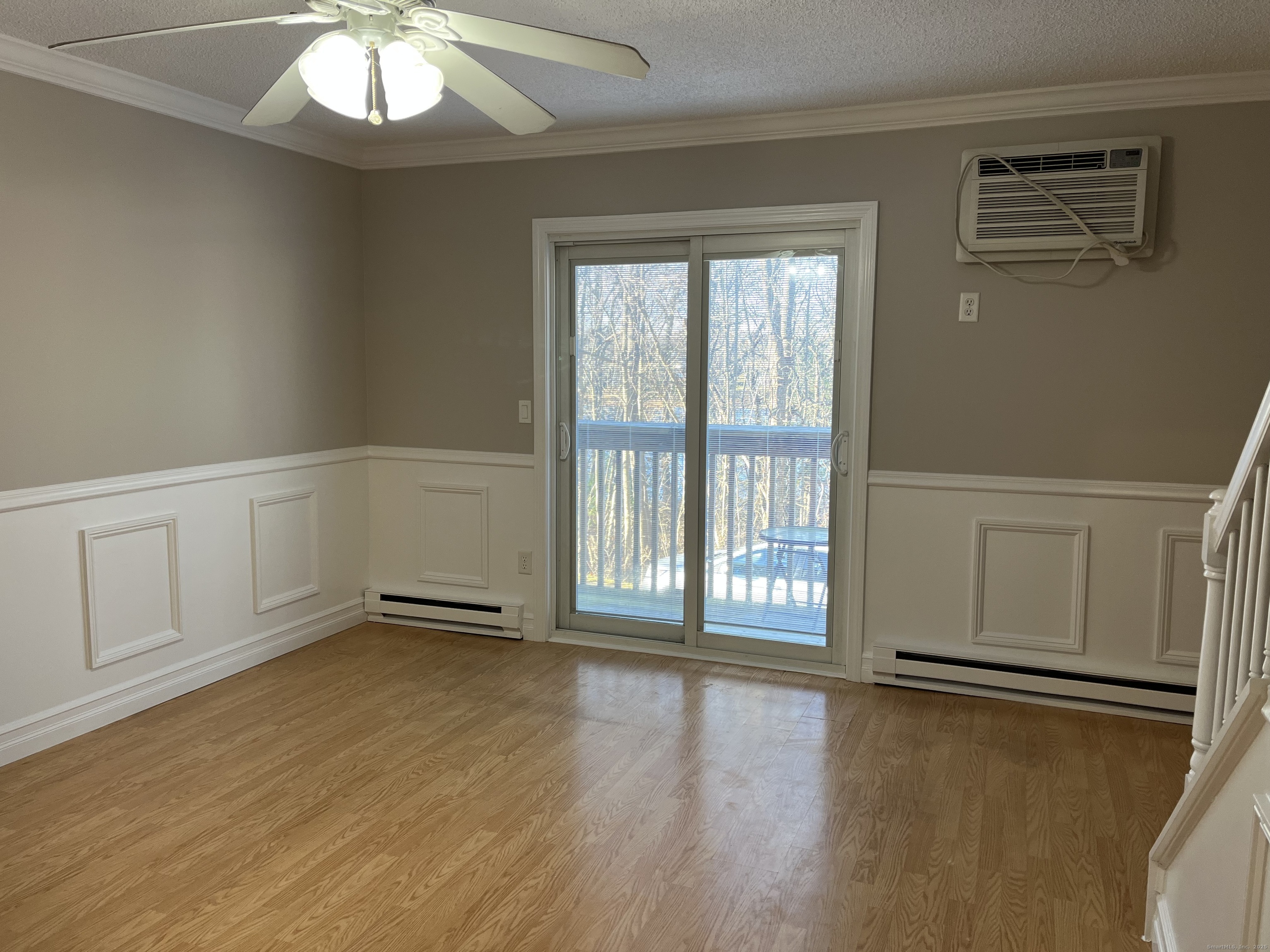 585 Park Road, Unit 112 Waterbury, CT 06708 - Photo 4 of 14 a view of an empty room with a window and wooden floor