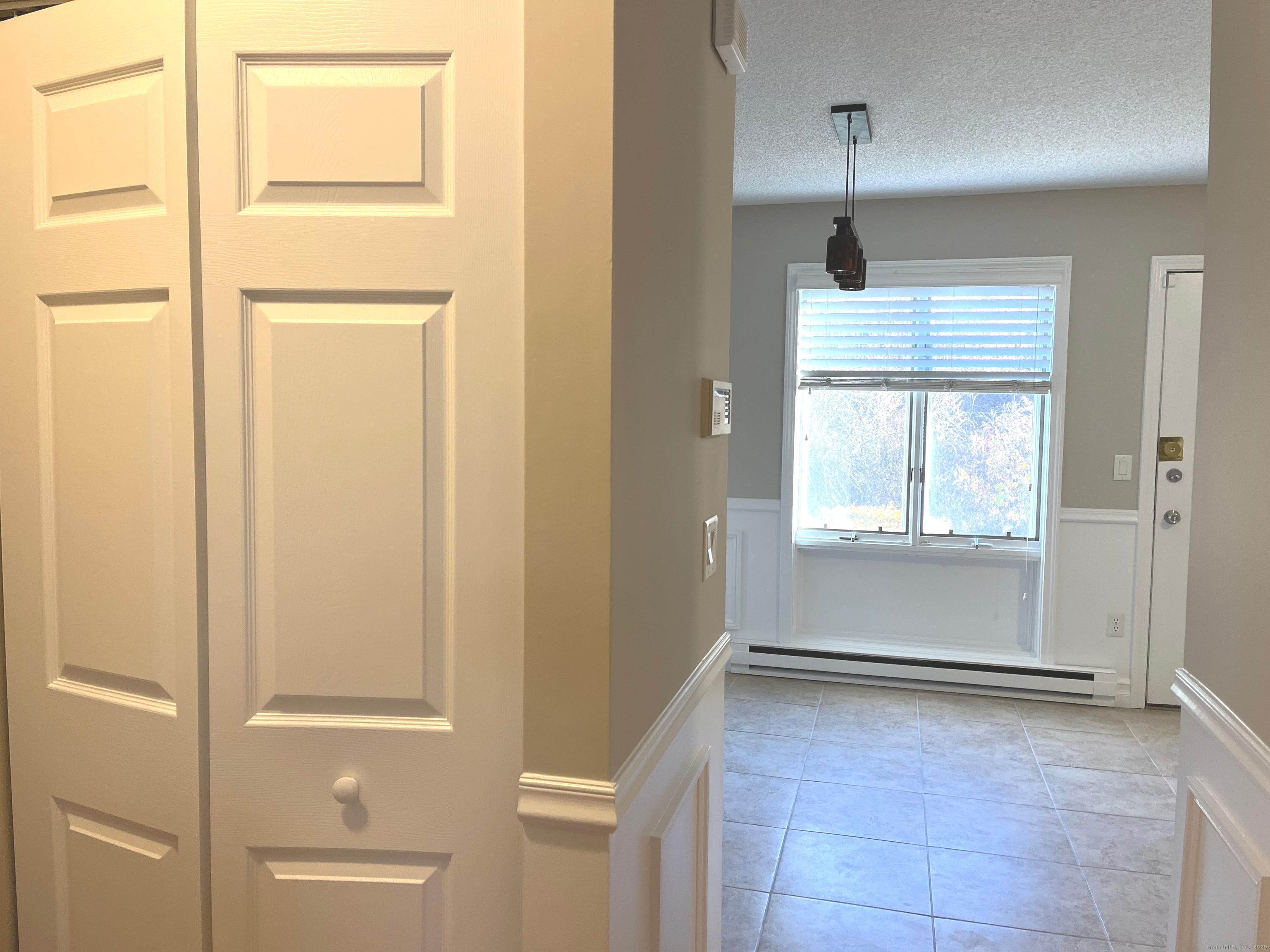 585 Park Road, Unit 112 Waterbury, CT 06708 - Photo 5 of 14 a view of an empty room with a window