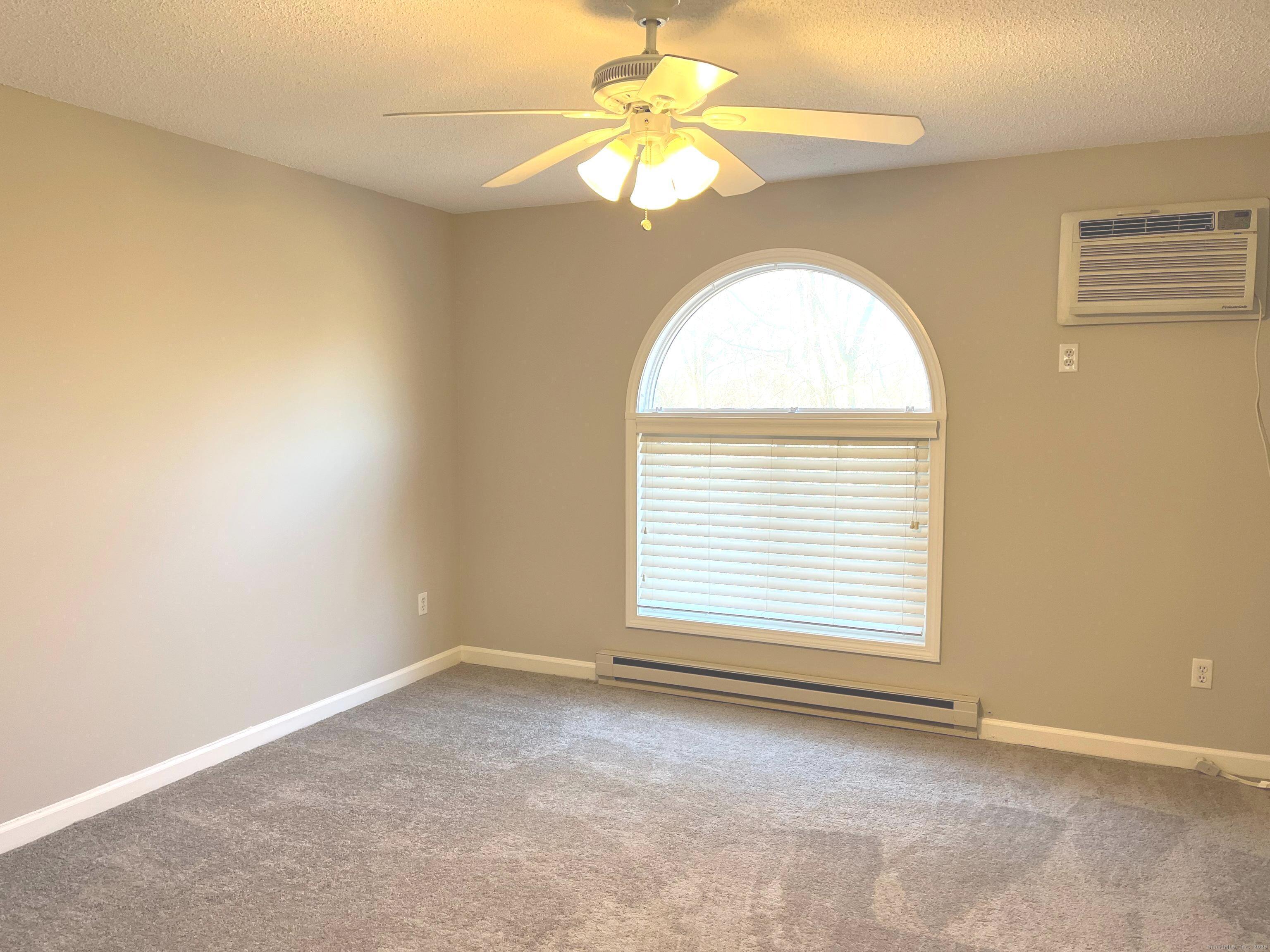 585 Park Road, Unit 112 Waterbury, CT 06708 - Photo 7 of 14 an empty room with a window and a fan