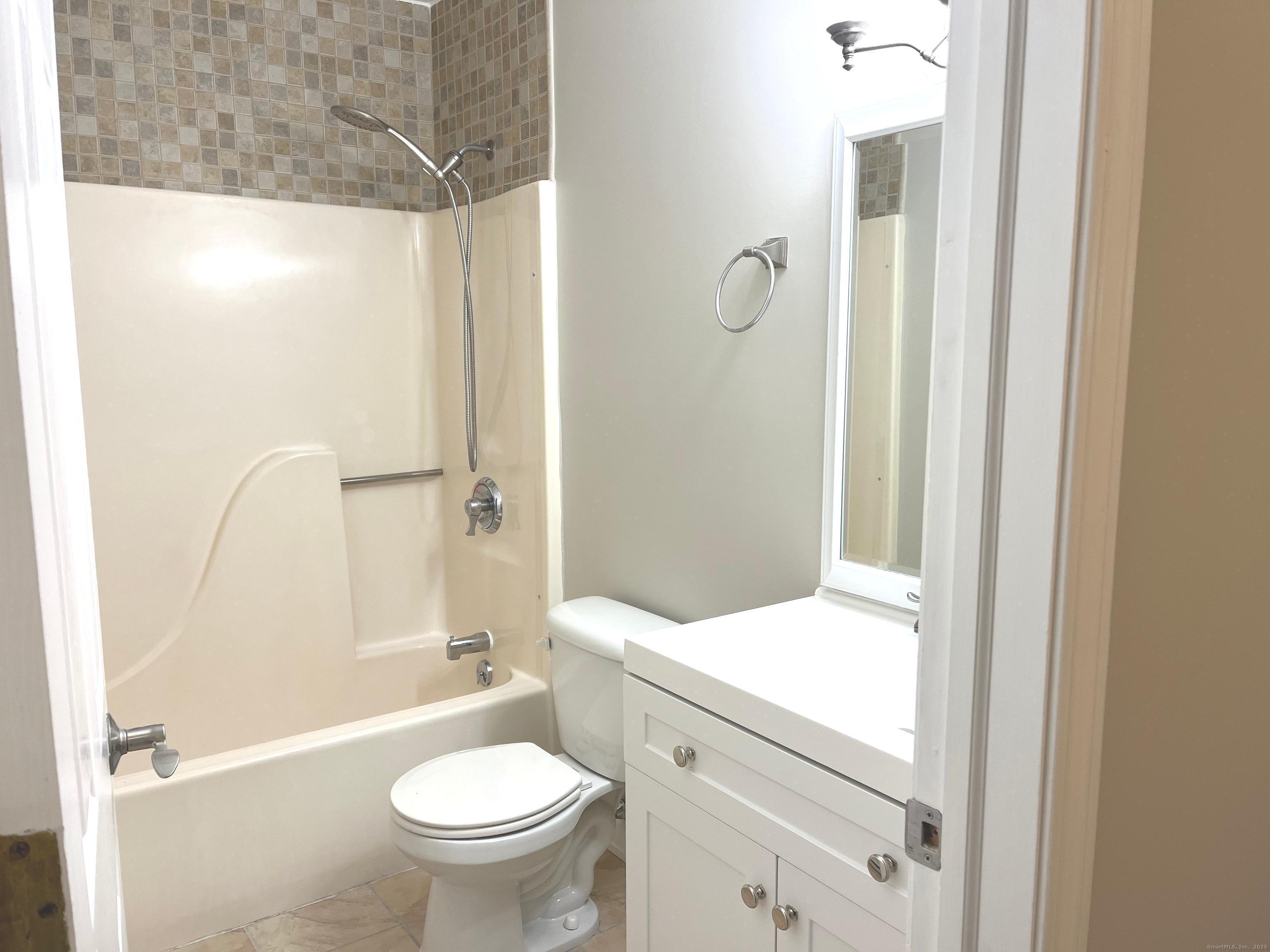 585 Park Road, Unit 112 Waterbury, CT 06708 - Photo 9 of 14 a bathroom with a granite countertop sink toilet and shower