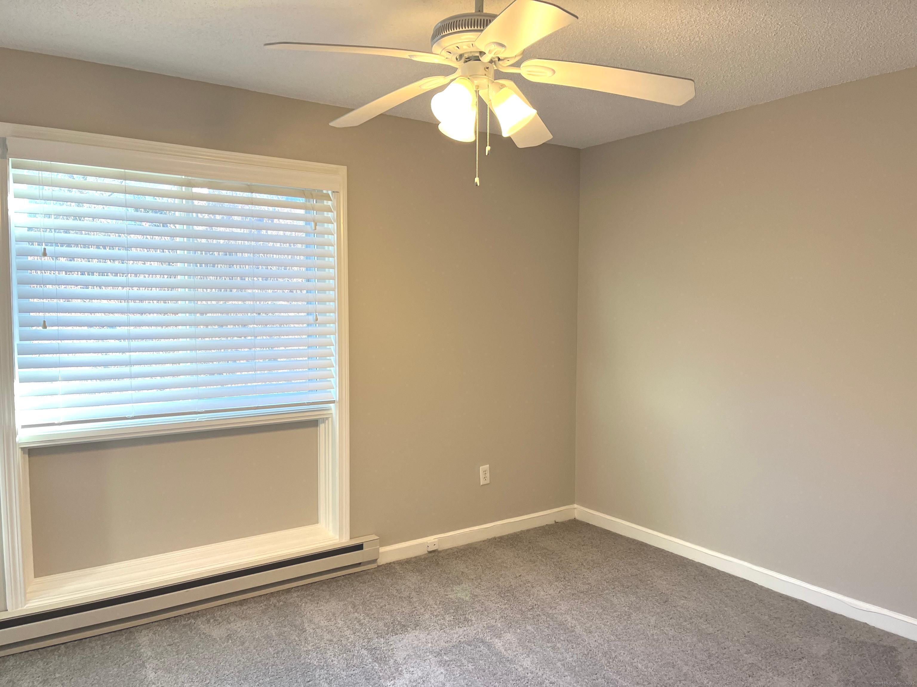 585 Park Road, Unit 112 Waterbury, CT 06708 - Photo 10 of 14 an empty room with a window and a fan