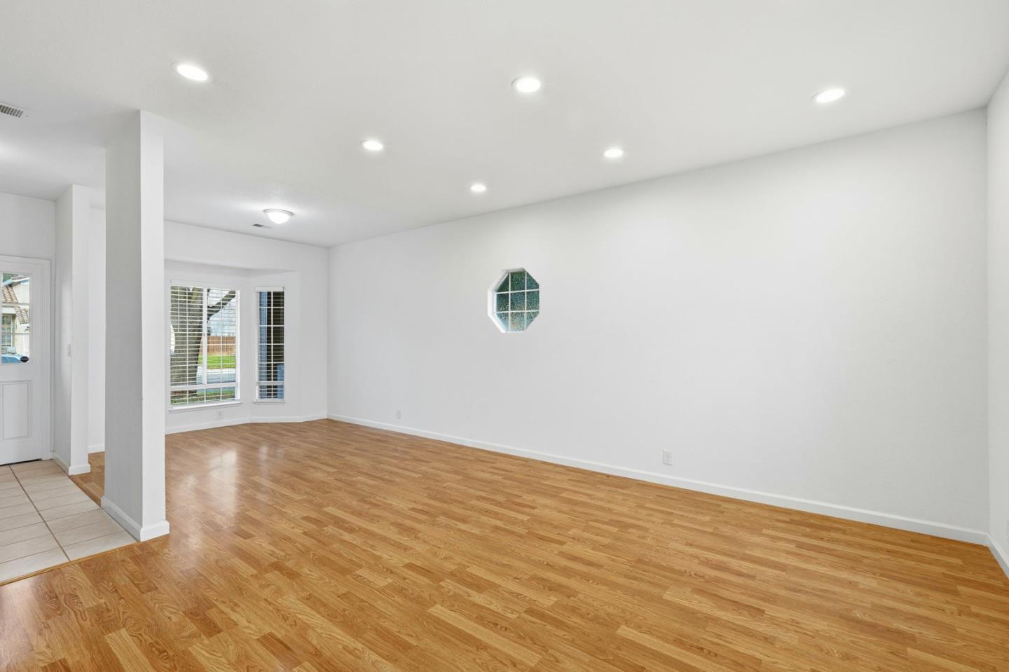 1672 Bailey Drive Ripon, CA 95366 - Photo 11 of 49 a view of an empty room with wooden floor and a window