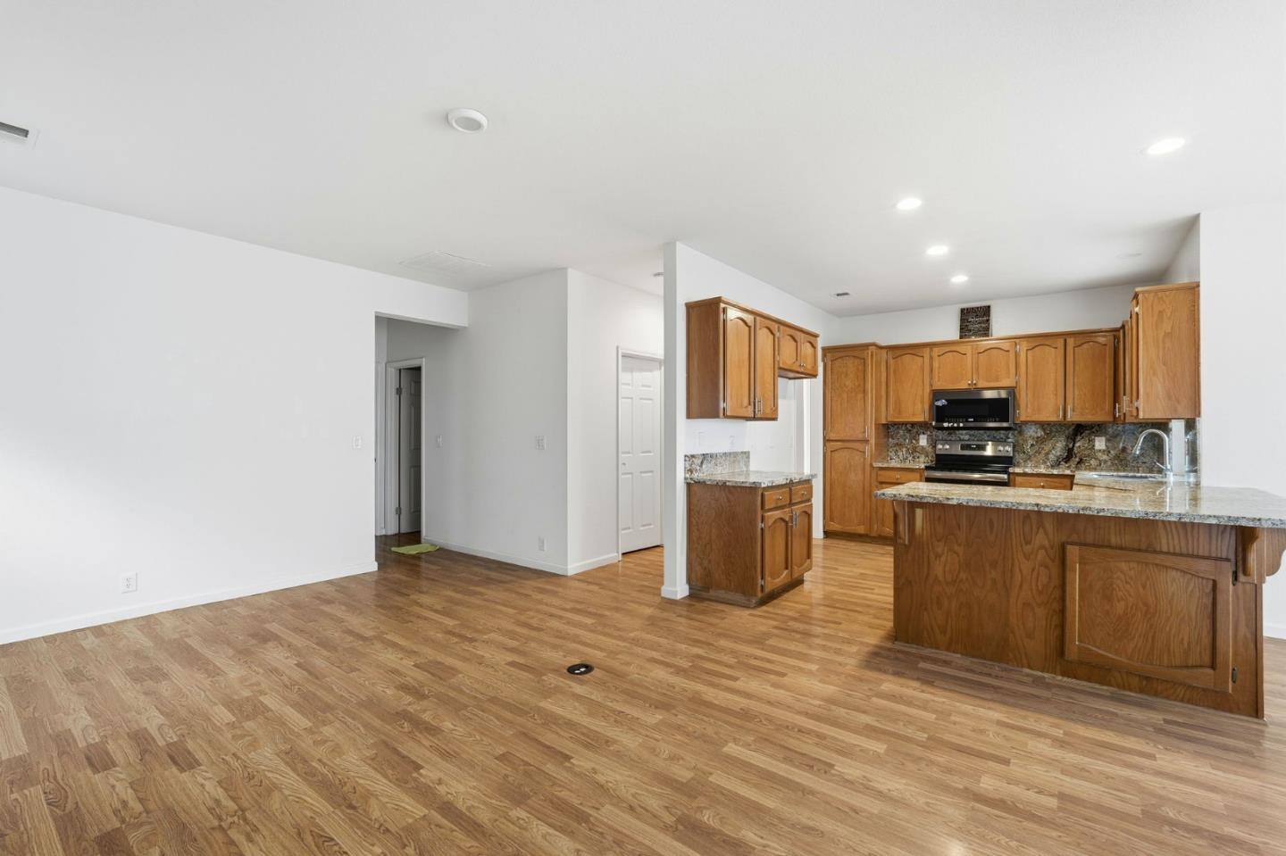 1672 Bailey Drive Ripon, CA 95366 - Photo 16 of 49 a view of kitchen with stainless steel appliances granite countertop a refrigerator and a stove top oven
