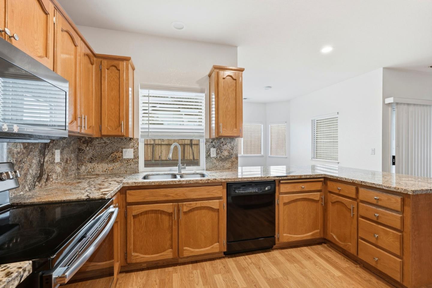 1672 Bailey Drive Ripon, CA 95366 - Photo 17 of 49 a kitchen with a sink stove and cabinets