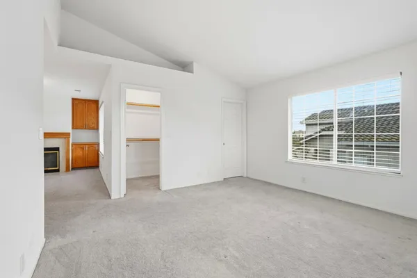 an empty room with a kitchen and a window