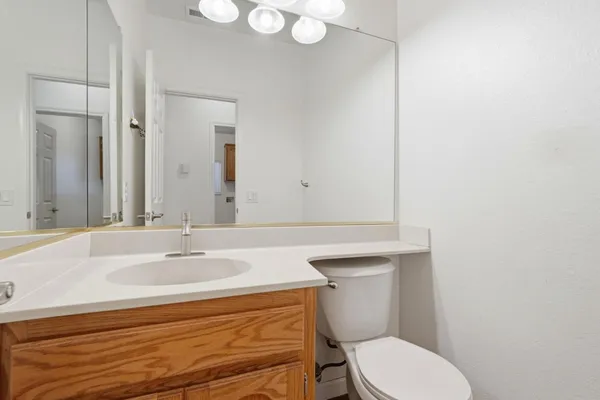 a bathroom with a sink double vanity granite tub and a mirror