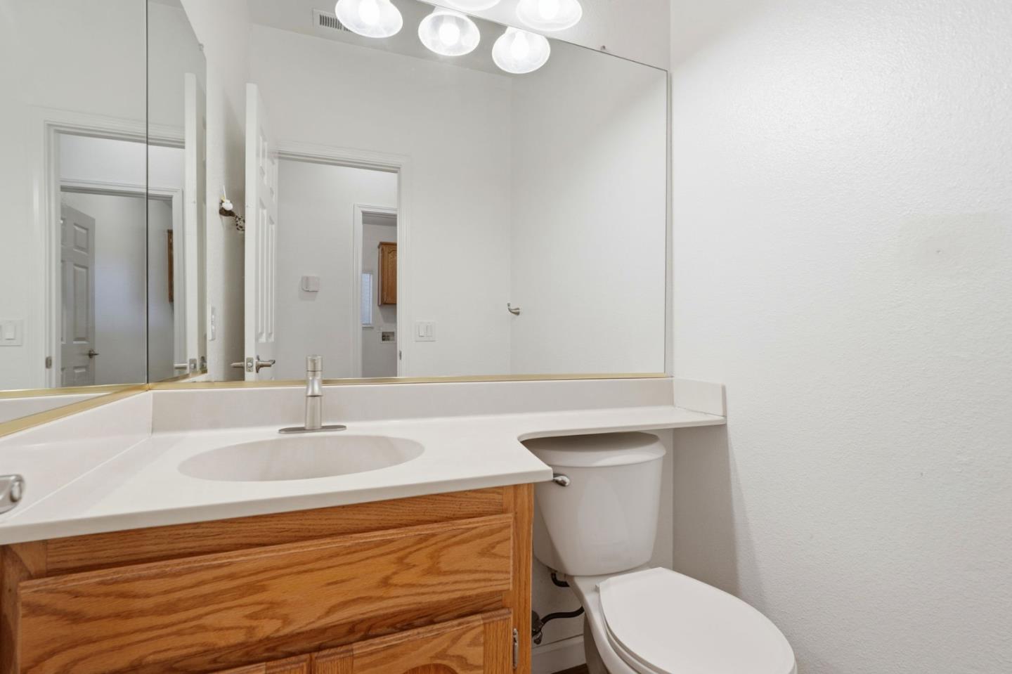 1672 Bailey Drive Ripon, CA 95366 - Photo 39 of 49 a bathroom with a sink a toilet and mirror