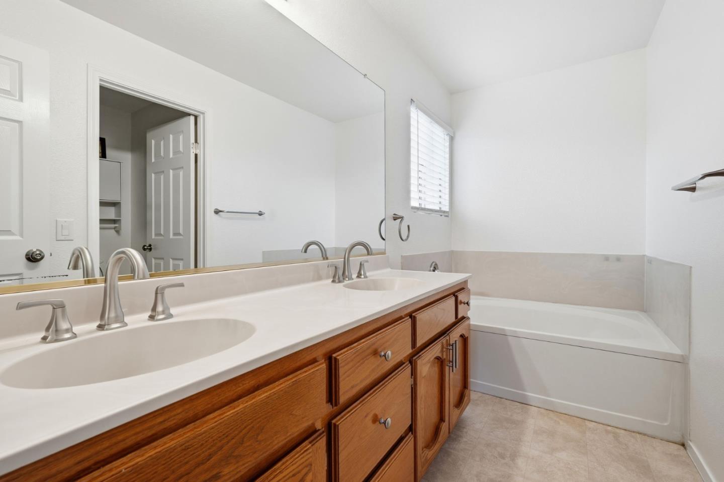 1672 Bailey Drive Ripon, CA 95366 - Photo 40 of 49 a bathroom with a sink double vanity granite tub and a mirror