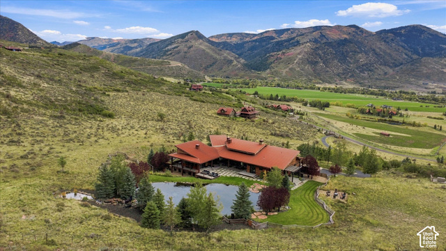 5936 Triple Crown Trail Oakley, UT 84055 - Photo 44 of 57 Expansive property featuring a private pond, surrounding trees, and a terraced lawn area