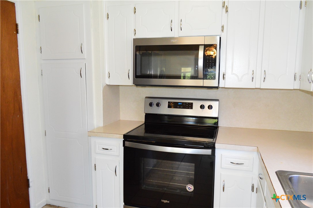1404 Rob Lane Copperas Cove, TX 76522 - Photo 14 of 31 a kitchen with a stove and a microwave